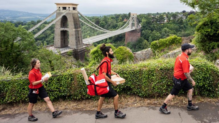 Postal workers carrying packages